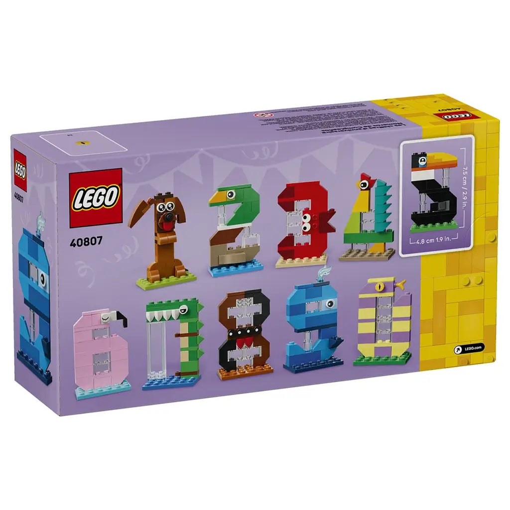 LEGO birthday numbers set packaging with colorful animal-inspired digit models, shown as buildable age decorations in a lavender box presentation on a studio background.