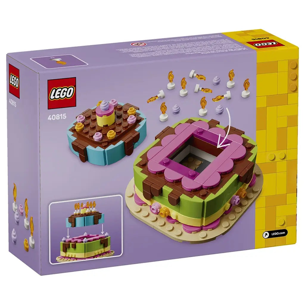 LEGO birthday cake building set packaging showing purple and yellow glossy cardboard panels, layered cake model with removable top section, candle accessories and display features on a clean studio background.