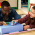 LEGO Bluey Grannies playset in purple, teal, tan, green, pink, and lavender plastic is enjoyed by a smiling adult and child as they roll the toy car beside the sandcastle scene.