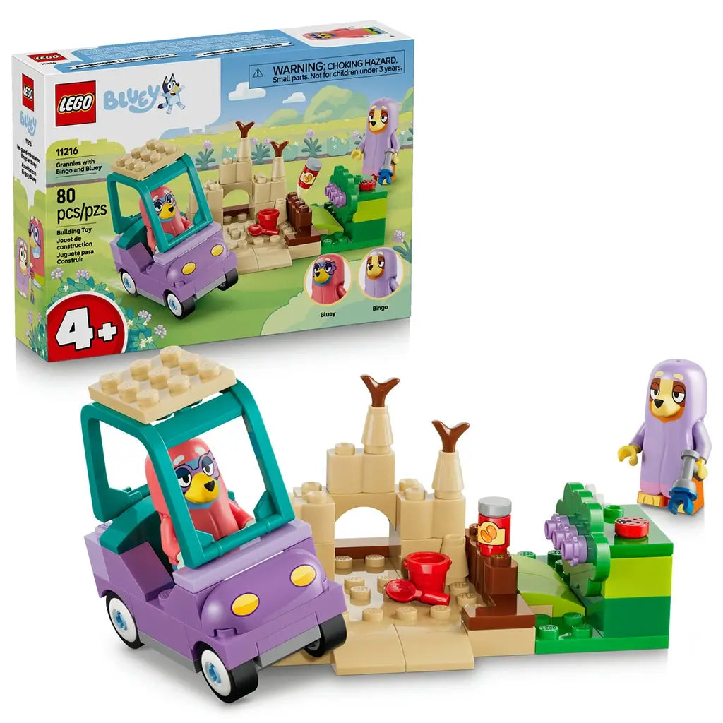 LEGO Bluey Grannies with Bingo and Bluey 11216 pairs the retail box with a purple and teal car, tan sandcastle, green garden, two figures, and small beach accessories.