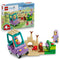 LEGO Bluey Grannies with Bingo and Bluey 11216 pairs the retail box with a purple and teal car, tan sandcastle, green garden, two figures, and small beach accessories.