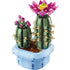 LEGO Botanicals Flowering Cactus set showing green plastic brick cactus with beige spines and a bright pink flower, sculpted cylindrical form for decorative display, arranged in a light blue pot on a clean background.