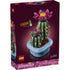 LEGO Botanicals Flowering Cactus box front with deep purple packaging showing green cactus build with vivid pink flower, detailed plastic brick botanical model for decorative display, photographed against a dark studio background.