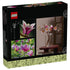 LEGO Botanicals Magnolia Branches box back shows pink and white plastic flowers on brown stems arranged in a glass vase, with product details and lifestyle images on dark branded packaging background.
