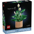 LEGO Botanicals Peace Lily box front with black packaging showing green leaf clusters and white peace lily blooms, detailed plastic brick botanical model for adult decorative display, photographed against a dark studio background.