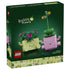 LEGO Botanicals Rocking Plants set 11506 box front features pink and light green smiling planters topped with leafy flowers, pictured on dark green retail packaging.