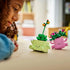 LEGO Botanicals Rocking Plants in pink and light green plastic bricks form two smiling planters with curved arms, green foliage and colorful flowers on a white background.