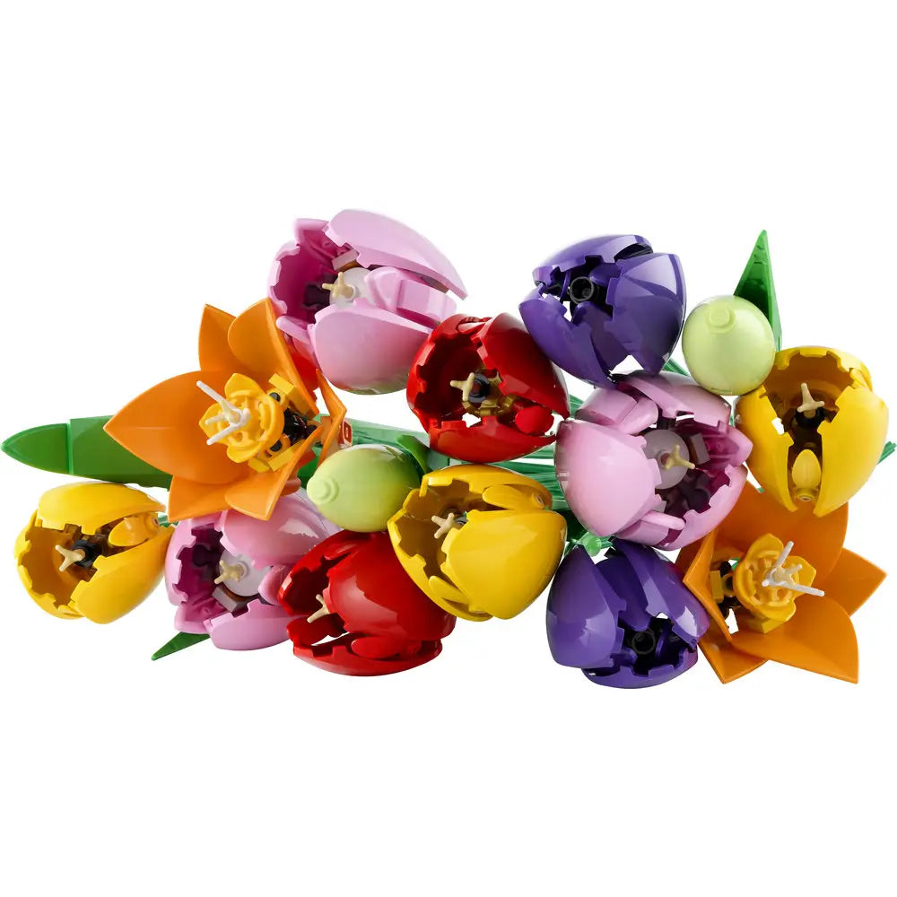 LEGO tulip bouquet features bright red, yellow, purple, pink, and orange plastic petals with smooth curved forms, designed as a decorative floral arrangement, photographed isolated on a white studio background.