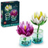 LEGO Botanicals Water Lilies 11511 in white, yellow, pink, purple, green, and clear plastic form two detailed blooms in round display bases beside the set box.
