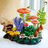 LEGO Botanicals Woodland Mushrooms display combines orange spotted caps, yellow and brown fungi, purple flowers, and green plastic ferns in a detailed forest scene.