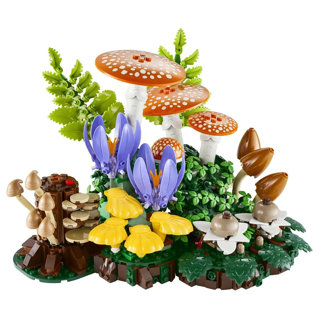 LEGO Botanicals Woodland Mushrooms model combines orange spotted caps, yellow and brown fungi, purple flowers, and layered green plastic foliage on a forest floor base.