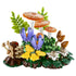 LEGO Botanicals Woodland Mushrooms model combines orange spotted caps, yellow and brown fungi, purple flowers, and layered green plastic foliage on a forest floor base.