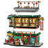 LEGO Spring Festival restaurant in green, red, gold and tan plastic is shown in three removable modular levels with lanterns, dining areas and storefront on white.