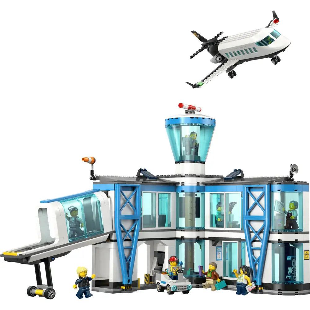 LEGO City airport playset featuring white and blue plastic modular buildings with clear windows, control tower, jet bridge, and passenger airplane, designed for imaginative airport travel play.