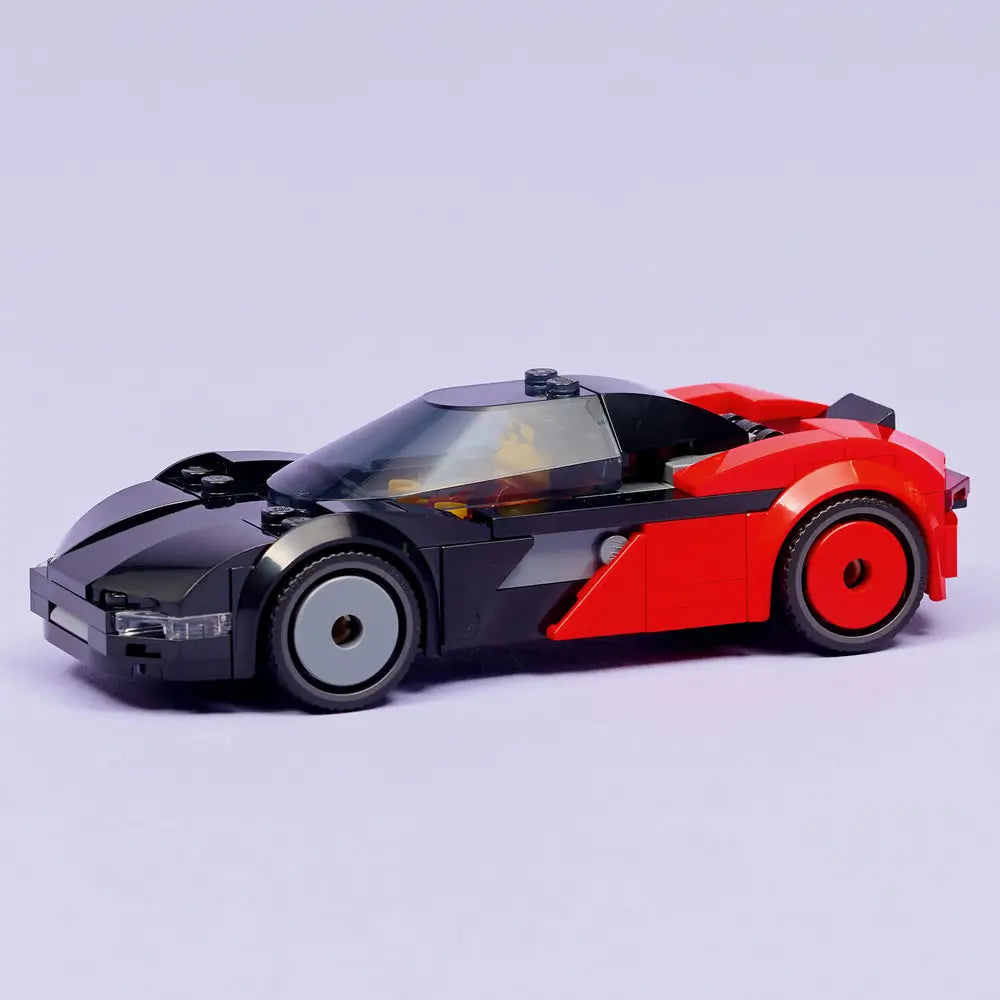 LEGO City EV Supercar fully built display model in black and red plastic bricks, sleek aerodynamic form, rounded wheel arches, enclosed windshield, and low stance, photographed on a neutral light background.