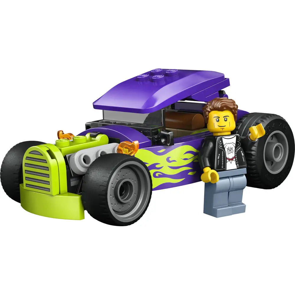 LEGO City Hot Rod car built from purple and lime green plastic bricks, featuring a compact low hot rod shape, exposed engine details, flame graphics, wide wheels, and a minifigure driver on a white background.