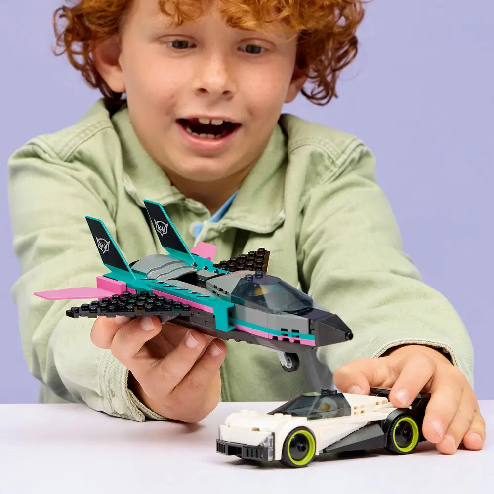 LEGO City Jet vs Car lifestyle builder scene featuring a child holding the completed jet while guiding the white sports car below, demonstrating scale, play value, and imaginative racing action.