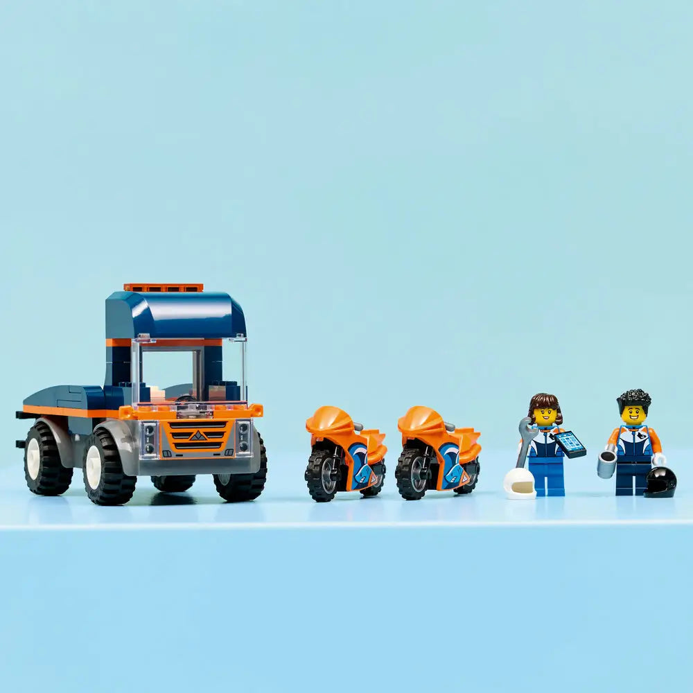 LEGO City motorcycle transporter playset fully assembled on display, showing a blue and orange transport truck carrying two sport motorcycles with rider minifigures and accessories.