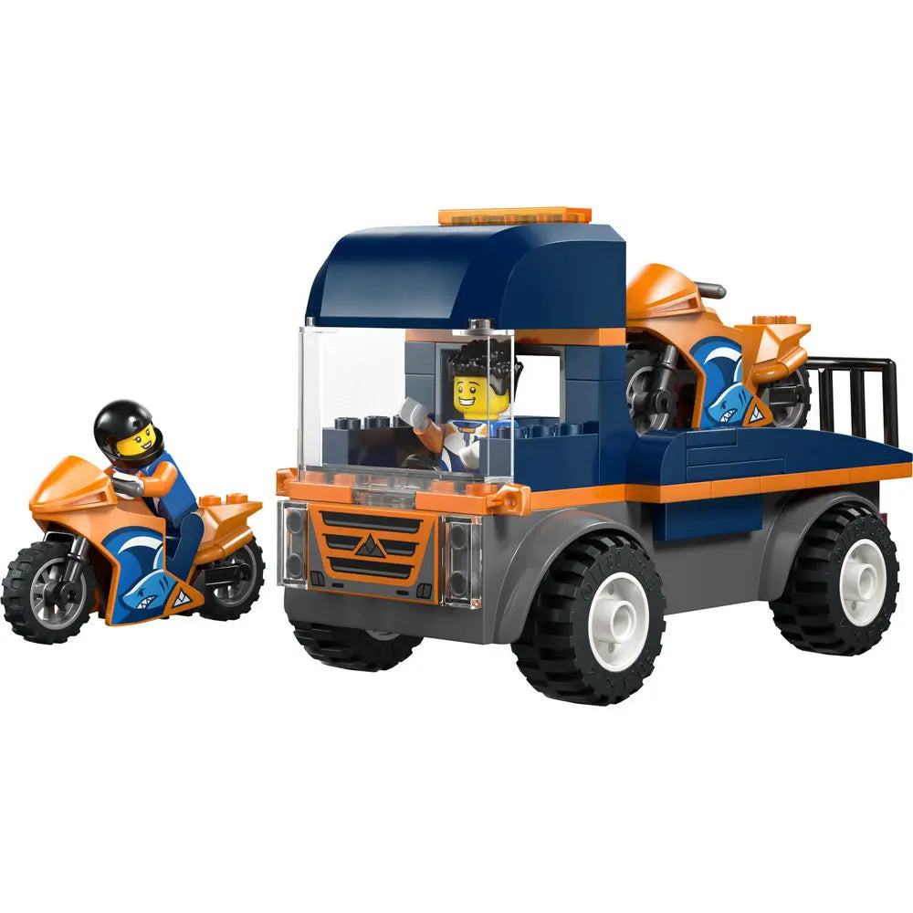 LEGO City motorcycle transporter toy featuring a blue and orange plastic transport truck with a boxy cab, open flatbed, chunky rolling wheels, and two sport motorcycles for racing play.