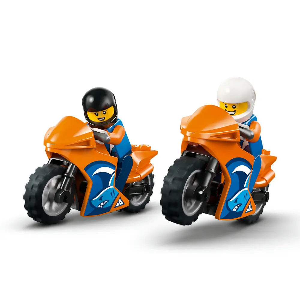 LEGO City sport motorcycles shown with riders, featuring orange and blue plastic bikes, thick treaded tires, racing graphics, and helmeted minifigures posed for action scenes.