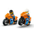 LEGO City sport motorcycles shown with riders, featuring orange and blue plastic bikes, thick treaded tires, racing graphics, and helmeted minifigures posed for action scenes.
