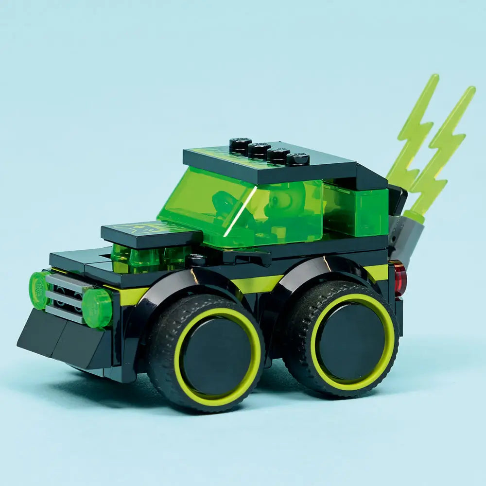 LEGO City Gaming Car fully built display model in black and neon green plastic bricks, boxy futuristic form, transparent green cab, wide tires, and rear lightning bolt element on a clean light blue background.