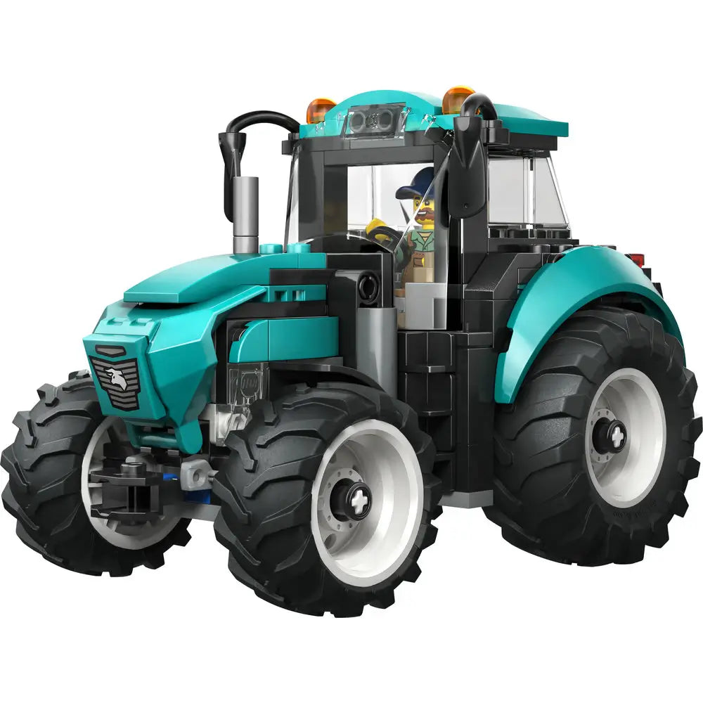 LEGO City tractor toy featuring a teal and black plastic farm tractor with large textured tires, enclosed cab, roof lights, and a farmer minifigure designed for imaginative farm play.