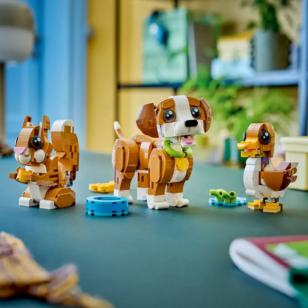 LEGO Creator 3-in-1 animal models displayed together on a tabletop, showing a brown and white puppy, a duck, and a squirrel made from smooth plastic bricks in a bright indoor room.