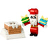 LEGO Creator Christmas set featuring a red and white Santa Claus figure holding two colorful presents beside a snow-covered brick chimney, built from interlocking plastic blocks.