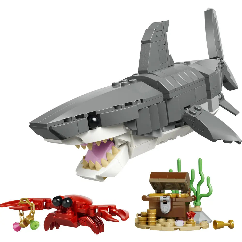 LEGO Creator shark toy built from gray and white plastic bricks with a smooth glossy texture, angular body shape, open jaw with pointed teeth, extended fins, and ocean accessories, displayed on a clean white studio background.