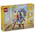 LEGO Creator Floral Art 31390 box in yellow and pastel tones, showing the 348-piece 3-in-1 butterfly and flower painting on a brown easel with brush, palette and paint tube.
