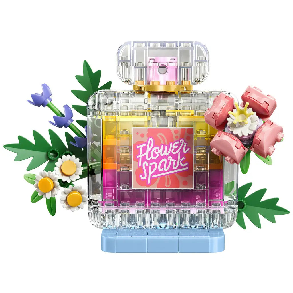 LEGO Creator floral perfume bottle in clear, pink, yellow, green, and blue plastic bricks features a square Flower Spark label, leafy stems, daisies, and pink blooms.