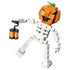 LEGO Creator Halloween skeleton toy in orange, white, black and translucent amber plastic bricks, shaped as a pumpkin-headed figure holding a lantern, isolated on a clean studio background.