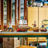 LEGO Creator pirate builds in brown, white and black plastic, displaying a tall pirate hideout, large sailing ship and two smaller ships with minifigures on a table.