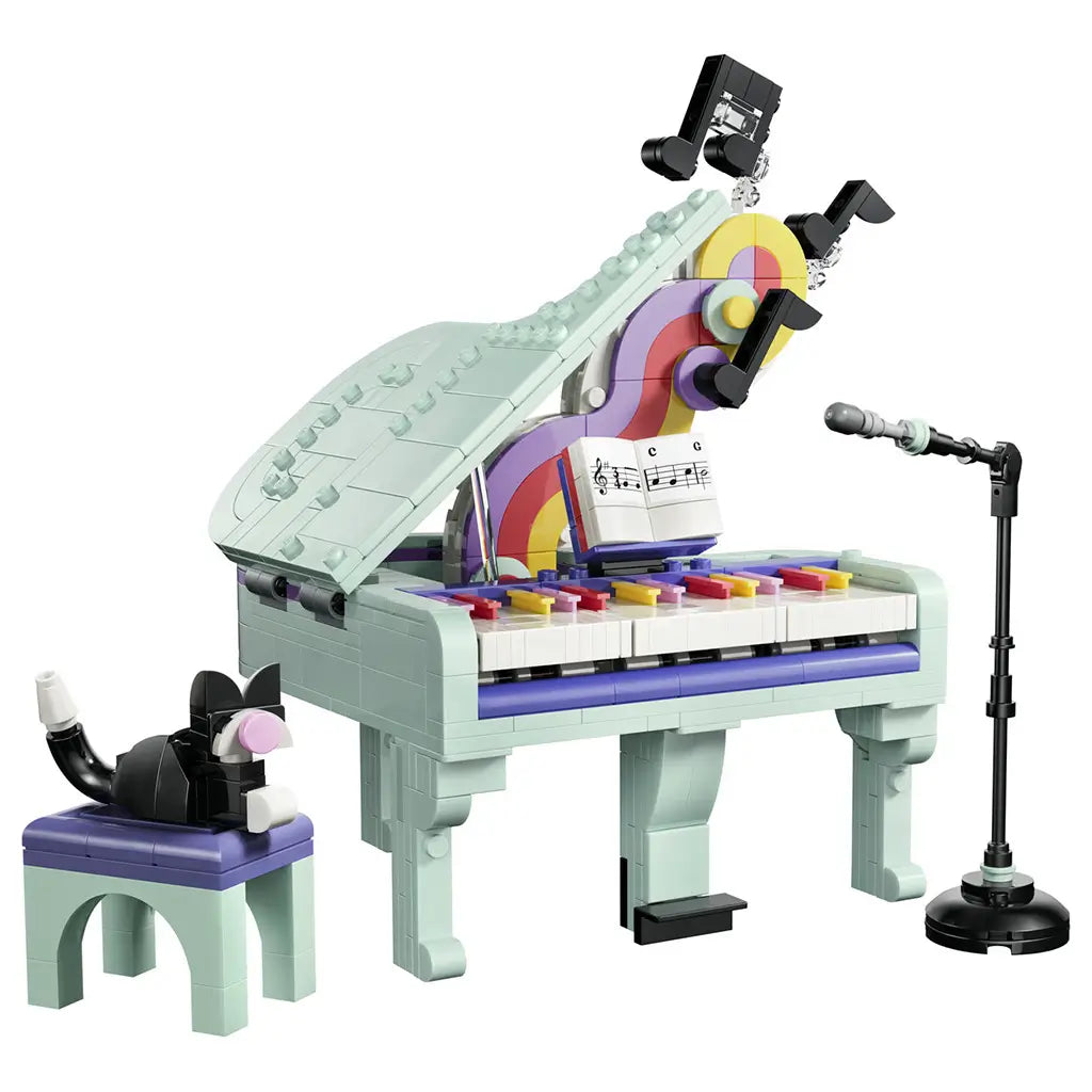LEGO Creator Music Decor Piano 31392 in mint, purple and pink plastic, featuring a grand piano with colorful keys, sheet music, black cat on a stool and microphone stand.