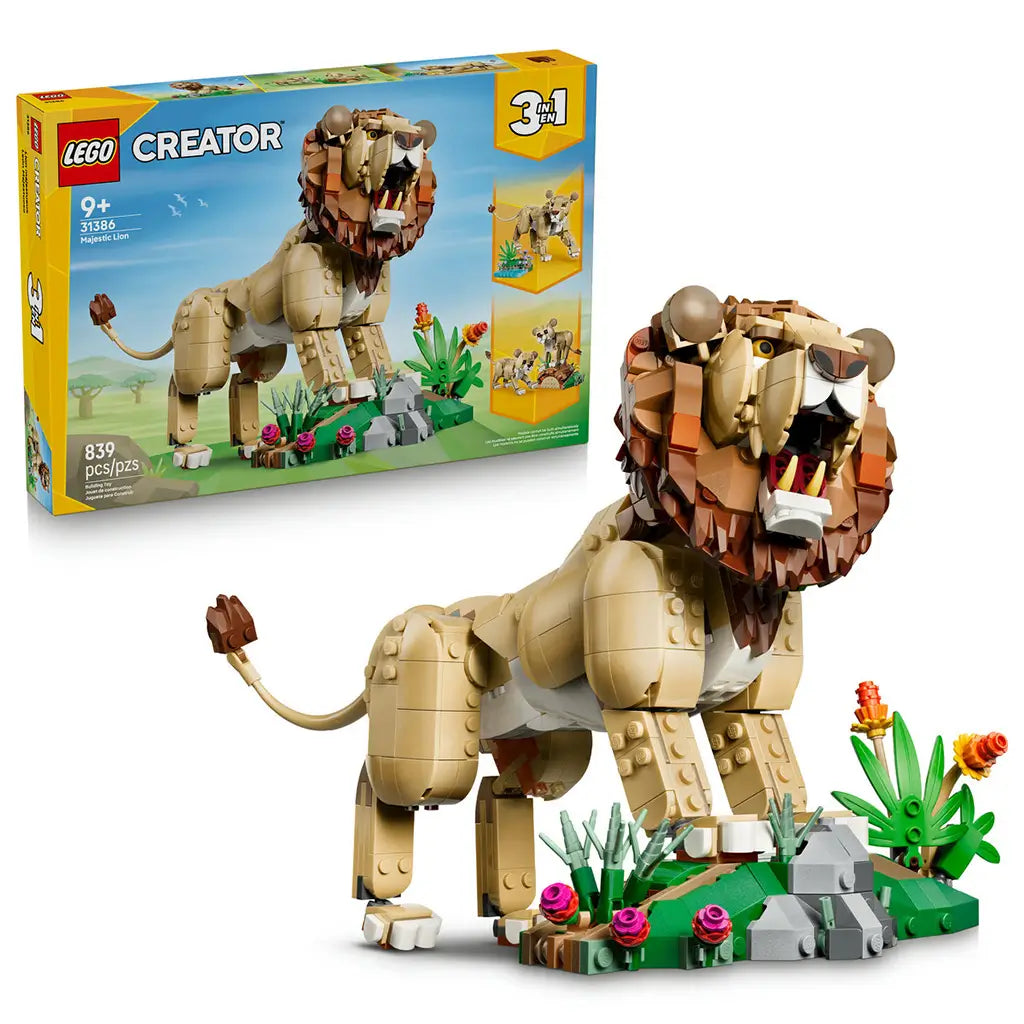 LEGO Creator Majestic Lion 31386 in tan, brown and green plastic, displayed with its retail box and a detailed flower-and-rock habitat against a white background.