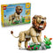 LEGO Creator Majestic Lion 31386 in tan, brown and green plastic, displayed with its retail box and a detailed flower-and-rock habitat against a white background.