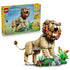 LEGO Creator Majestic Lion 31386 in tan, brown and green plastic, displayed with its retail box and a detailed flower-and-rock habitat against a white background.