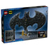 LEGO Batman logo package back in blue cardboard, rectangular box showing display stand, features, and gold minifigure bonus, product details illustrated on a stylized city skyline background.