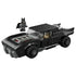 LEGO Batman Batmobile model in black plastic bricks, low wide muscle car shape with exposed engine detail, shown with Batman minifigure on a plain white background.