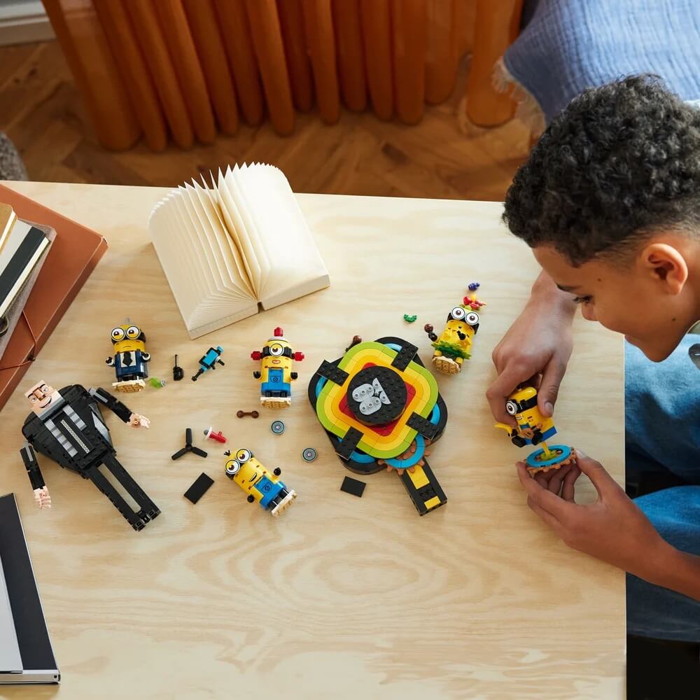 Image of a box playing LEGO® Despicable Me Brick-Built Gru and Minions 839 Piece Building Set (75582) on top of table