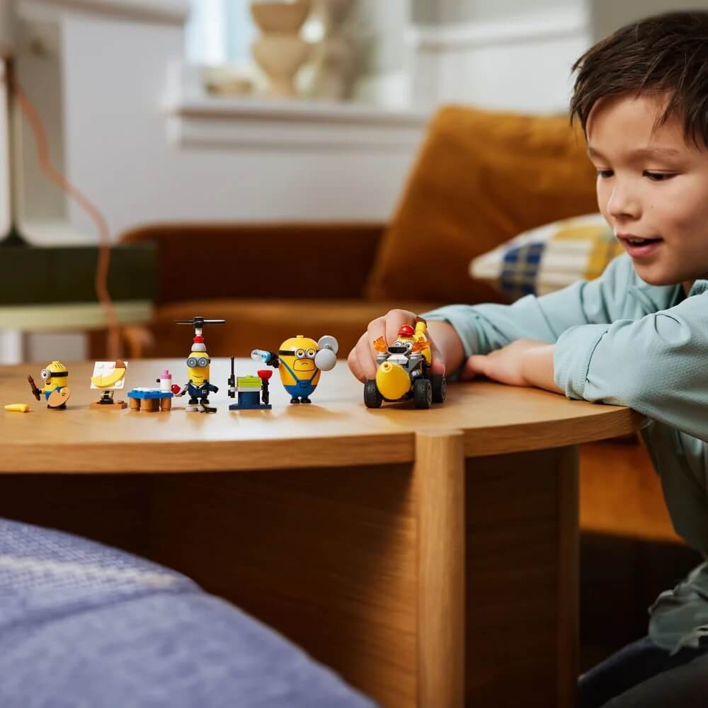 another image of boy playing LEGO® Despicable Me Minions and Banana Car 136 Piece Building Set (75580)
