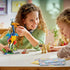 LEGO Disney Pixar Up Kevin and Dug build in colorful plastic, children interacting with tall bird figure and dog model, playful construction scene with accessories on a bright indoor table setting.