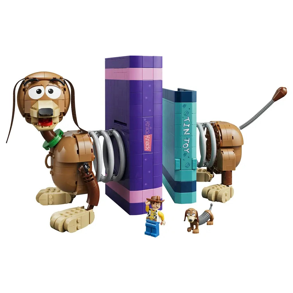 LEGO Disney Pixar Toy Story Slinky Dog Bookends feature brown, tan, purple and teal plastic components forming character bookends, display books and Woody minifigure accents on a light studio background.