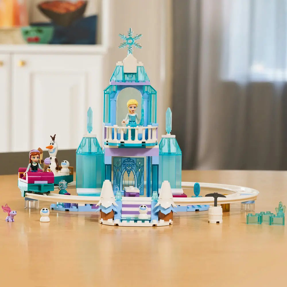 LEGO Disney Frozen Elsa’s Ice Castle fully assembled in translucent blue plastic, tall crystal-style tower with balcony and snow ride track, displayed neatly on a table in a softly lit home environment.