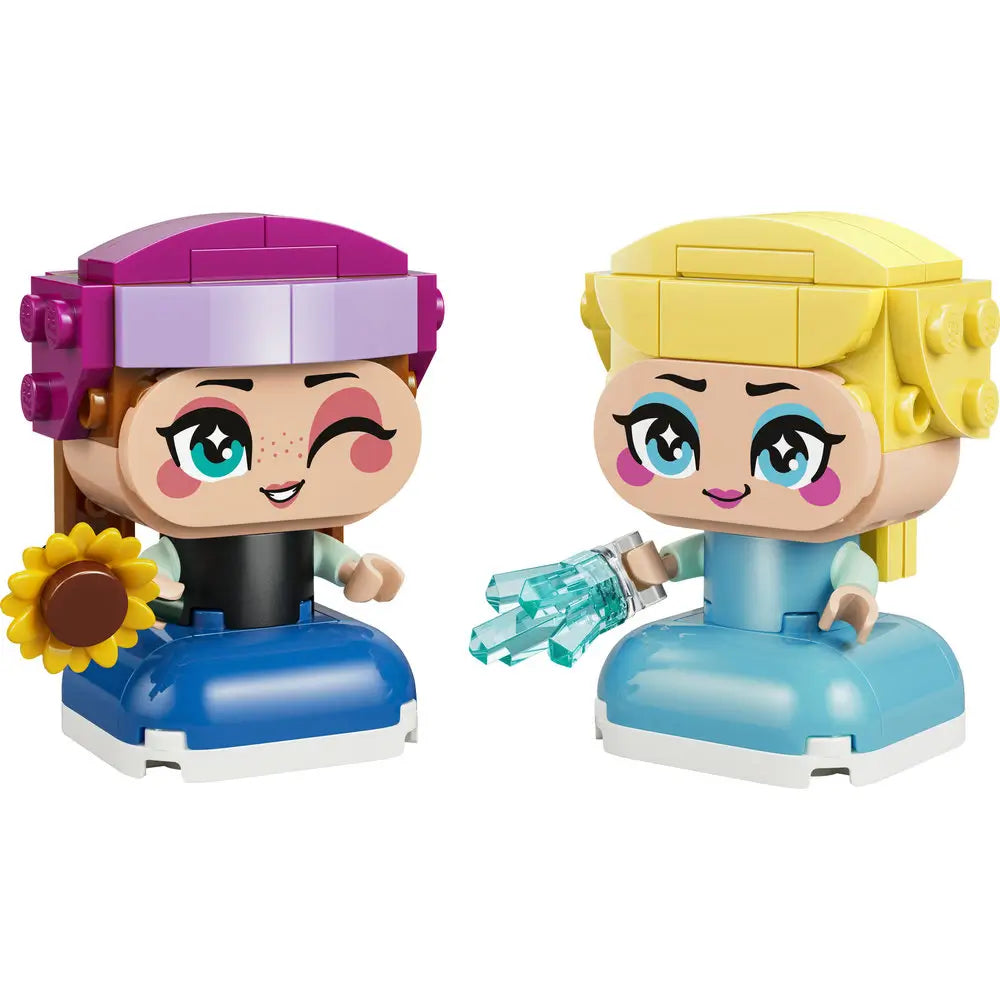 LEGO Disney Frozen Mini Anna and Elsa figures featuring smooth plastic mini-doll bodies, rounded cartoon-style heads, bright facial expressions, Anna with purple hat and sunflower, and Elsa in a light blue dress holding icy accessories on a white background.