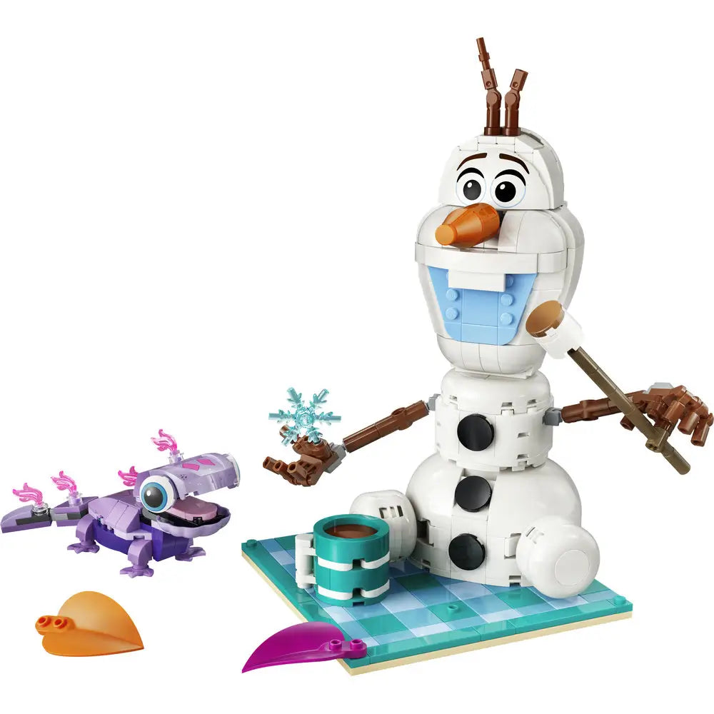 LEGO Disney Frozen Olaf building toy featuring white plastic snowman body, rounded stacked shapes, carrot nose, twig arms, light blue chest tiles, picnic accessories, and Bruni salamander on a white background.