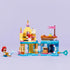 LEGO Disney Princess Ariel’s Magical Mini Palace fully built and displayed, featuring pastel yellow towers, teal platforms, shell accents, small boat, and Ariel, Sebastian, and Flounder figures arranged neatly.