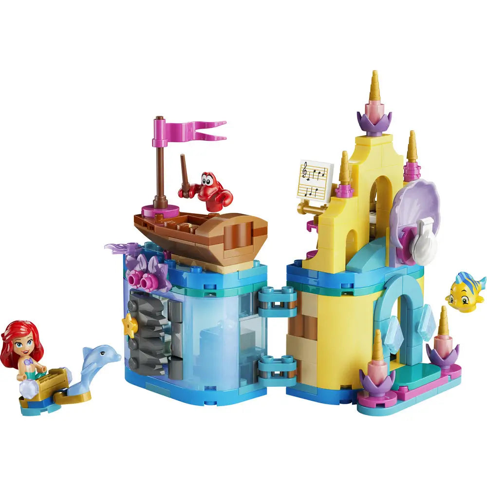 LEGO Disney Princess Ariel’s Magical Mini Palace playset featuring pastel yellow, teal, and pink plastic bricks, rounded palace towers, shell-shaped doorway, small boat, and Ariel, Sebastian, and Flounder figures on a white background.
