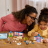 LEGO Disney Princess Cinderella Animal Friends Castle in blue, pink, and white plastic is assembled on a table as an adult and child smile while building together.